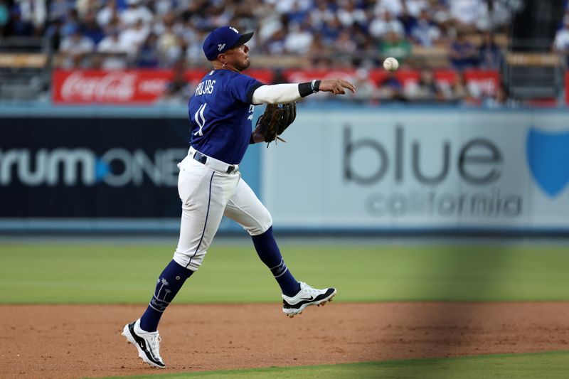 Aug 3, 2023; Los Angeles, California, USA;  Los Angeles Dodgers shortstop Miguel Rojas (11) throws a ball to first base during the second inning against the Oakland Athletics at Dodger Stadium. Mandatory Credit: Kiyoshi Mio-USA TODAY Sports