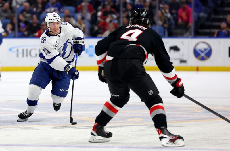 Apr 5, 2025; Buffalo, New York, USA;  Tampa Bay Lightning center Brayden Point (21) skates up ice with the puck during the first period against the Buffalo Sabres at KeyBank Center. Mandatory Credit: Timothy T. Ludwig-Imagn Images