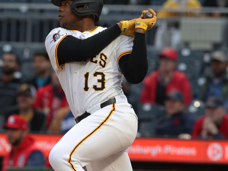 Apr 7, 2025; Pittsburgh, Pennsylvania, USA;  Pittsburgh Pirates third baseman Ke'Bryan Hayes (13) hits an RBI single against the St. Louis Cardinals during the second inning at PNC Park. Mandatory Credit: Charles LeClaire-Imagn Images