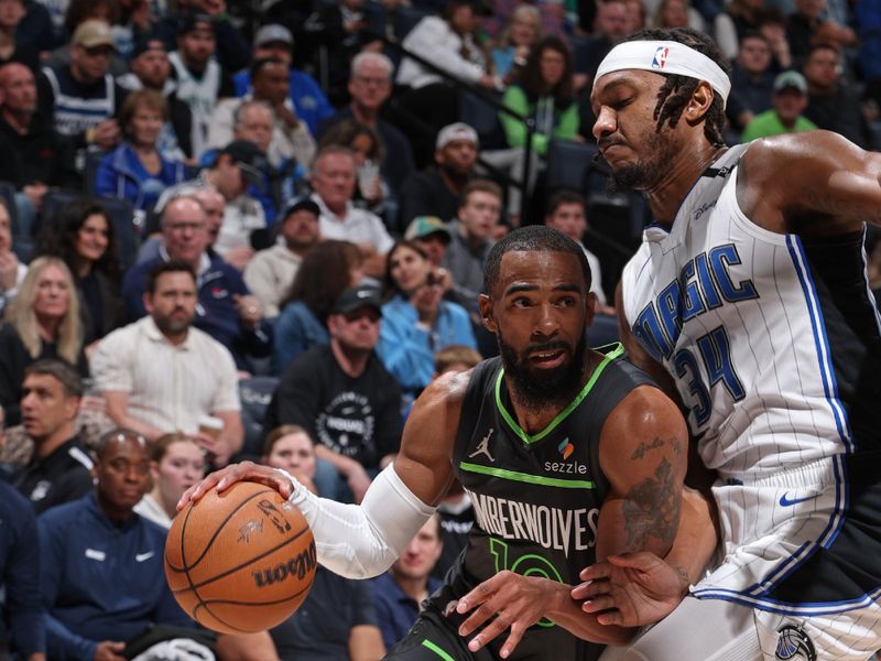 MINNEAPOLIS, MN -  MARCH 14:  Mike Conley #10 of the Minnesota Timberwolves dribbles the ball during the game against the Orlando Magic  on March 14, 2025 at Target Center in Minneapolis, Minnesota. NOTE TO USER: User expressly acknowledges and agrees that, by downloading and or using this Photograph, user is consenting to the terms and conditions of the Getty Images License Agreement. Mandatory Copyright Notice: Copyright 2025 NBAE (Photo by David Sherman/NBAE via Getty Images)