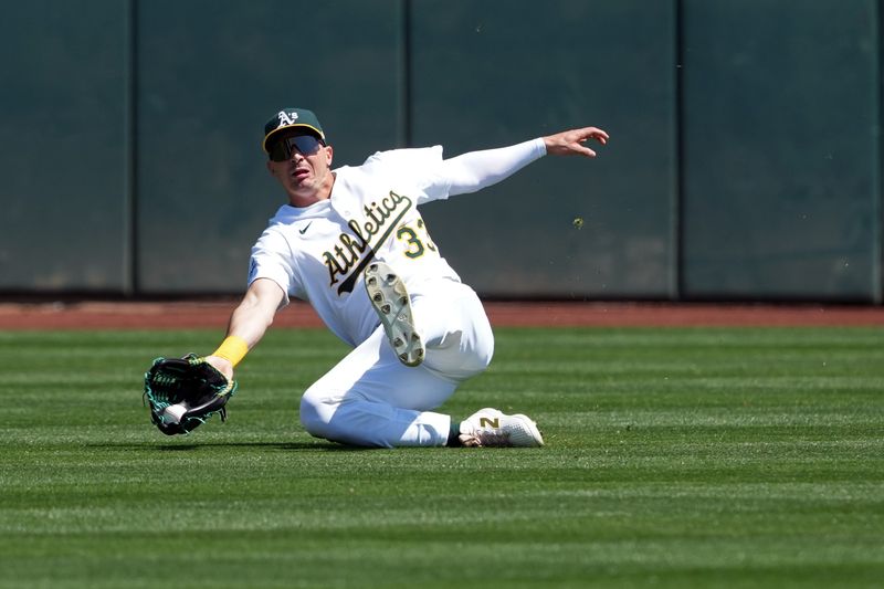 Apr 9, 2025; West Sacramento, California, USA; Athletics center fielder JJ Bleday (33) is unable to catch a fly ball during the first inning against the San Diego Padres at Sutter Health Park. Mandatory Credit: Darren Yamashita-Imagn Images