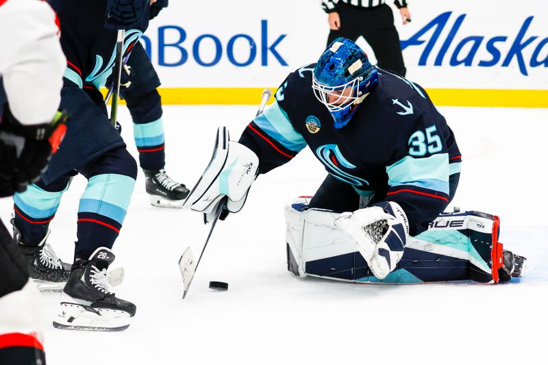 Jan 4, 2024; Seattle, Washington, USA; Seattle Kraken goaltender Joey Daccord (35) collects the puck during the first period against the Ottawa Senators at Climate Pledge Arena. Mandatory Credit: Joe Nicholson-USA TODAY Sports