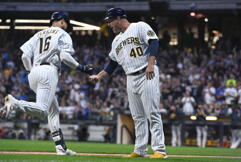 Sep 30, 2023; Milwaukee, Wisconsin, USA; Milwaukee Brewers right fielder Blake Perkins (16) is congratulated by Milwaukee Brewers third base coach Jason Lane (40) after hitting a home run against the Chicago Cubs in the second inning at American Family Field. Mandatory Credit: Michael McLoone-USA TODAY Sports