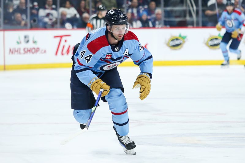 Dec 4, 2023; Winnipeg, Manitoba, CAN;   Winnipeg Jets defenseman Josh Morrissey (44) chases the puck against the Carolina Hurricanes during the first period at Canada Life Centre. Mandatory Credit: Terrence Lee-USA TODAY Sports