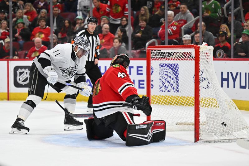 Mar 15, 2024; Chicago, Illinois, USA; Los Angeles Kings forward Anze Kopitar (11) redirects the puck past Chicago Blackhawks goaltender Arvid Soderblom (40) for his second goal of the first period at United Center. Mandatory Credit: Jamie Sabau-USA TODAY Sports