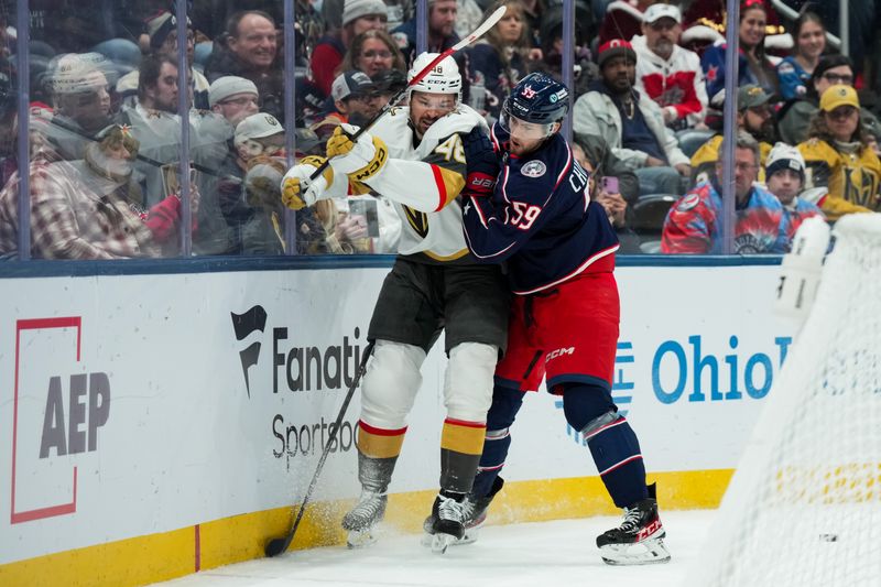 Dec 13, 2025; Columbus, Ohio, USA;  Columbus Blue Jackets right wing Yegor Chinakhov (59) battles for the puck against Vegas Golden Knights center Tomas Hertl (48) in the second period at Nationwide Arena. Mandatory Credit: Aaron Doster-Imagn Images