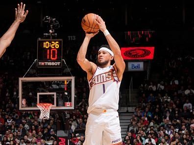 TORONTO, CANADA - NOVEMBER 29:  Devin Booker #1 of the Phoenix Suns shoots a three point basket during the game on November 29, 2023 at the Scotiabank Arena in Toronto, Ontario, Canada.  NOTE TO USER: User expressly acknowledges and agrees that, by downloading and or using this Photograph, user is consenting to the terms and conditions of the Getty Images License Agreement.  Mandatory Copyright Notice: Copyright 2023 NBAE (Photo by Mark Blinch/NBAE via Getty Images)