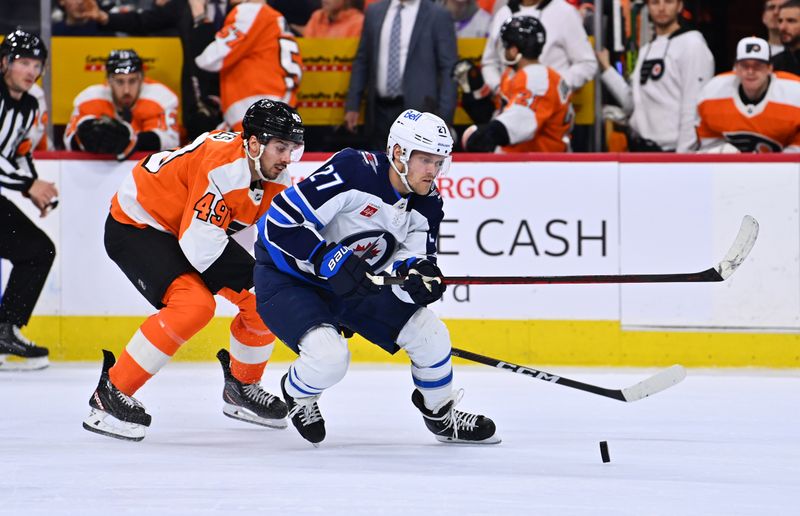 Jan 22, 2023; Philadelphia, Pennsylvania, USA; Winnipeg Jets left wing Nikolaj Ehlers (27) chases down the puck against Philadelphia Flyers left wing Noah Cates (49) in the second period at Wells Fargo Center. Mandatory Credit: Kyle Ross-USA TODAY Sports