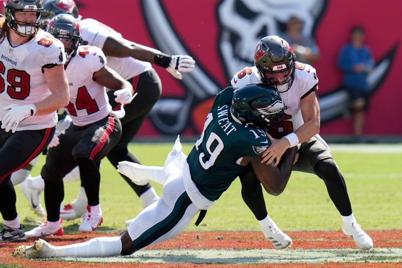 Tampa Bay Buccaneers' Baker Mayfield, right, is sacked by Philadelphia Eagles' Josh Sweat during the second half of an NFL football game, Sunday, Sept. 29, 2024, in Tampa, Fla. (AP Photo/Chris O'Meara)