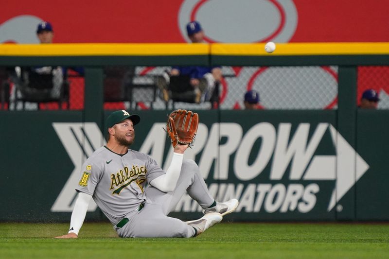 Apr 28, 2025; Arlington, Texas, USA; Athletics third baseman Max Schuemann (12) makes a sliding catch against the Texas Rangers during the second inning at Globe Life Field. Mandatory Credit: Raymond Carlin III-Imagn Images