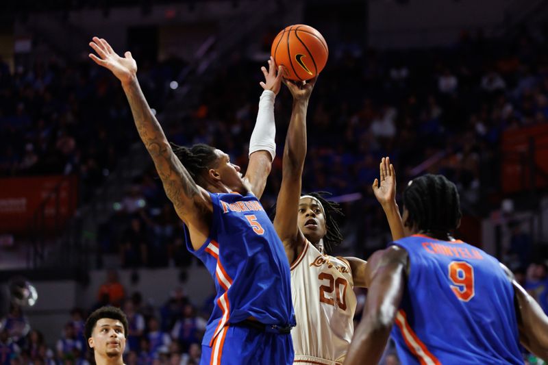 Jan 18, 2025; Gainesville, Florida, USA; Texas Longhorns guard Tre Johnson (20) shoots over Florida Gators guard Will Richard (5) during the first half at Exactech Arena at the Stephen C. O'Connell Center. Mandatory Credit: Matt Pendleton-Imagn Images