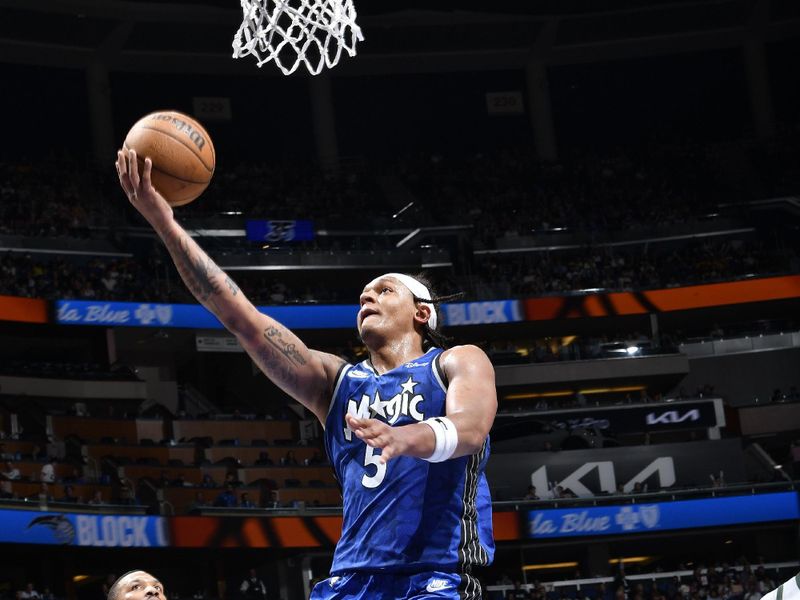 ORLANDO, FL - APRIL 14: Paolo Banchero #5 of the Orlando Magic drives to the basket during the game against the Milwaukee Bucks on April 14, 2024 at Kia Center in Orlando, Florida. NOTE TO USER: User expressly acknowledges and agrees that, by downloading and or using this photograph, User is consenting to the terms and conditions of the Getty Images License Agreement. Mandatory Copyright Notice: Copyright 2024 NBAE (Photo by Fernando Medina/NBAE via Getty Images)