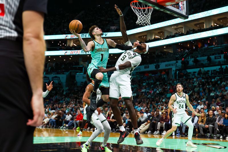 CHARLOTTE, NORTH CAROLINA - NOVEMBER 16: LaMelo Ball #1 of the Charlotte Hornets and Bobby Portis #9 of the Milwaukee Bucks collide mid-air during the first half of a basketball game at Spectrum Center on November 16, 2024 in Charlotte, North Carolina. NOTE TO USER: User expressly acknowledges and agrees that, by downloading and or using this photograph, User is consenting to the terms and conditions of the Getty Images License Agreement. (Photo by David Jensen/Getty Images)