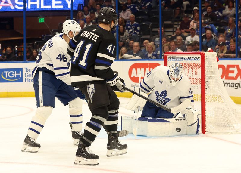 Apr 17, 2024; Tampa, Florida, USA; Tampa Bay Lightning right wing Mitchell Chaffee (41) shoots as Toronto Maple Leafs goaltender Martin Jones (31) makes a save and Toronto Maple Leafs defenseman Ilya Lyubushkin (46) defends during the first period at Amalie Arena. Mandatory Credit: Kim Klement Neitzel-USA TODAY Sports