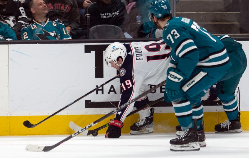 Mar 14, 2023; San Jose, California, USA; Columbus Blue Jackets center Liam Foudy (19) beats San Jose Sharks center Noah Gregor (73) to the puck during the first period at SAP Center at San Jose. Mandatory Credit: D. Ross Cameron-USA TODAY Sports