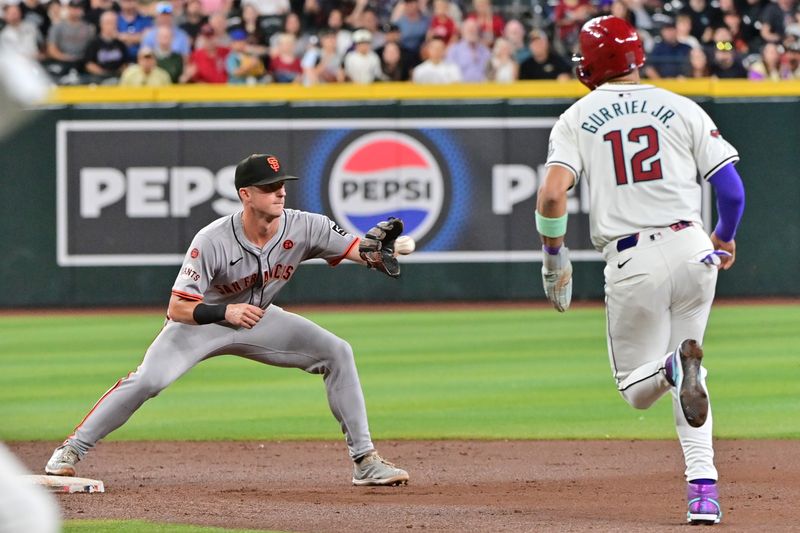 Sep 25, 2024; Phoenix, Arizona, USA; Arizona Diamondbacks outfielder Lourdes Gurriel Jr. (12) is out by San Francisco Giants shortstop Tyler Fitzgerald (49) in the second inning at Chase Field. Mandatory Credit: Matt Kartozian-Imagn Images