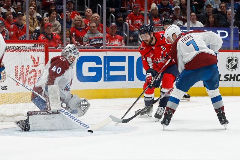 Feb 13, 2024; Washington, District of Columbia, USA; Colorado Avalanche goaltender Alexandar Georgiev (40) makes a save on Washington Capitals right wing Tom Wilson (43) as Avalanche defenseman Devon Toews (7) defends in the first period at Capital One Arena. Mandatory Credit: Geoff Burke-USA TODAY Sports