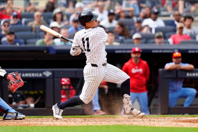 Aug 31, 2024; Bronx, New York, USA; New York Yankees shortstop Anthony Volpe (11) hits an RBI infield single against the St. Louis Cardinals during the eighth inning at Yankee Stadium. Mandatory Credit: Gregory Fisher-USA TODAY Sports