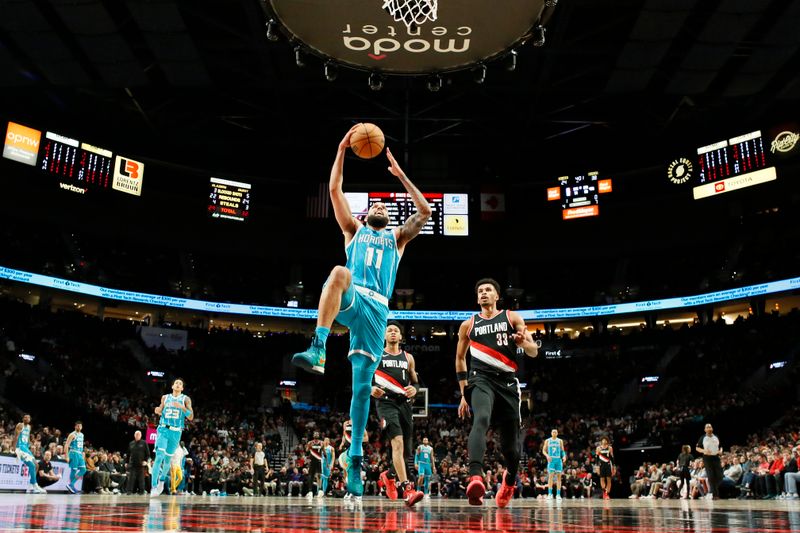 PORTLAND, OREGON - FEBRUARY 25: Cody Martin #11 of the Charlotte Hornets goes up for a dunk during the first half against the Portland Trail Blazers at Moda Center on February 25, 2024 in Portland, Oregon. NOTE TO USER: User expressly acknowledges and agrees that, by downloading and or using this photograph, User is consenting to the terms and conditions of the Getty Images License Agreement. (Photo by Soobum Im/Getty Images)