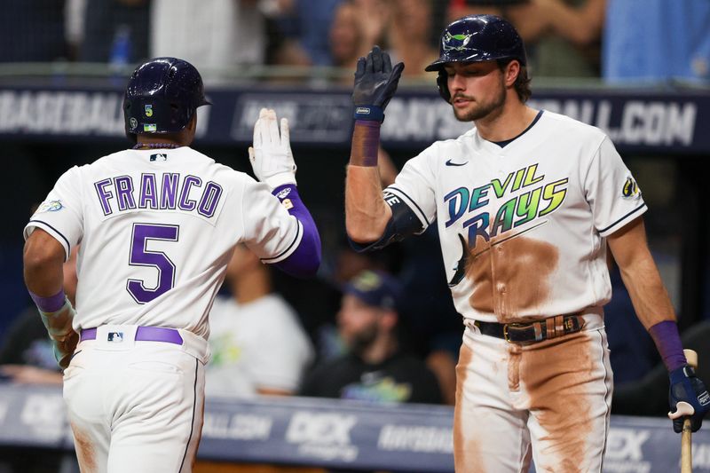 May 26, 2023; St. Petersburg, Florida, USA;  Tampa Bay Rays shortstop Wander Franco (5) is congratulated by designated hitter Josh Lowe (15) after scoring a run against the Los Angeles Dodgers in the seventh inning at Tropicana Field. Mandatory Credit: Nathan Ray Seebeck-USA TODAY Sports