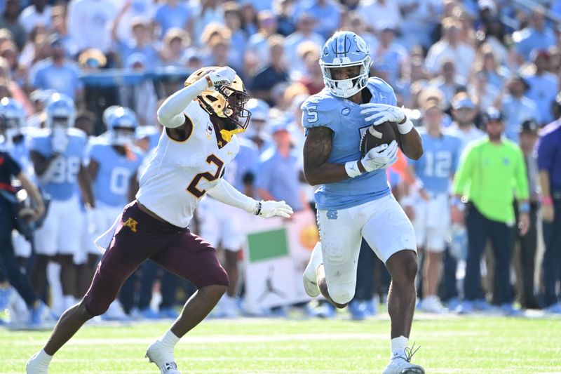 Sep 16, 2023; Chapel Hill, North Carolina, USA;  North Carolina Tar Heels wide receiver J.J. Jones (5) catches the ball as Minnesota Golden Gophers defensive back Tre'Von Jones (2) defends in the second quarter at Kenan Memorial Stadium. Mandatory Credit: Bob Donnan-USA TODAY Sports