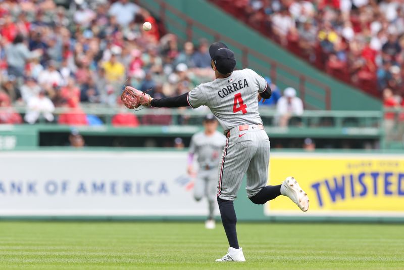 May 4, 2025; Boston, Massachusetts, USA; Minnesota Twins shortstop Carlos Correa (4) catches a pop fly during the second inning against the Boston Red Sox at Fenway Park. Mandatory Credit: Paul Rutherford-Imagn Images
