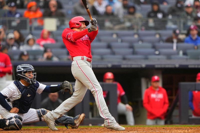 Apr 5, 2023; Bronx, New York, USA; Philadelphia Phillies right fielder Jake Cave (44) hits a sacrifice fly ball to drive in a run during the seventh inning against the New York Yankees at Yankee Stadium. Mandatory Credit: Gregory Fisher-USA TODAY Sports