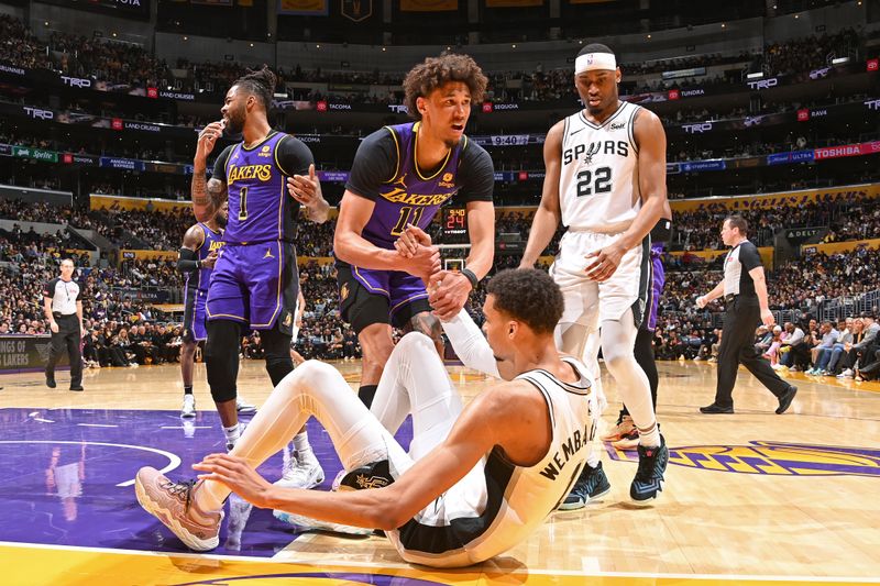 LOS ANGELES, CA - FEBRUARY 23: Jaxson Hayes #11 of the Los Angeles Lakers helps up Victor Wembanyama #1 of the San Antonio Spurs during the game on Feburary 23, 2024 at Crypto.Com Arena in Los Angeles, California. NOTE TO USER: User expressly acknowledges and agrees that, by downloading and/or using this Photograph, user is consenting to the terms and conditions of the Getty Images License Agreement. Mandatory Copyright Notice: Copyright 2024 NBAE (Photo by Andrew D. Bernstein/NBAE via Getty Images)