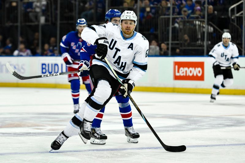 Oct 12, 2024; New York, New York, USA; Utah Hockey Club left wing Lawson Crouse (67) skates past New York Rangers center Mika Zibanejad (93) during the third period at Madison Square Garden. Mandatory Credit: John Jones-Imagn Images