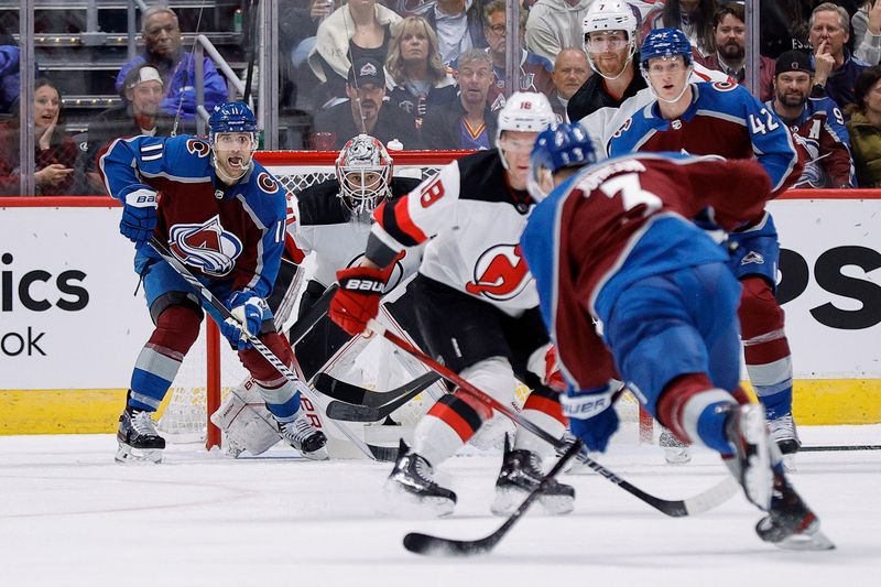 Nov 7, 2023; Denver, Colorado, USA; Colorado Avalanche defenseman Jack Johnson (3) attempts a shot as New Jersey Devils left wing Ondrej Palat (18) and defenseman Josh Manson (42) and center Andrew Cogliano (11) and defenseman Dougie Hamilton (7) and goaltender Vitek Vanecek (41) look on in the first period at Ball Arena. Mandatory Credit: Isaiah J. Downing-USA TODAY Sports