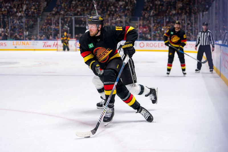 Mar 25, 2024; Vancouver, British Columbia, CAN; Vancouver Canucks forward Sam Lafferty (18) drives around Los Angeles Kings forward Alex Laferriere (78) in the first period at Rogers Arena. Mandatory Credit: Bob Frid-USA TODAY Sports