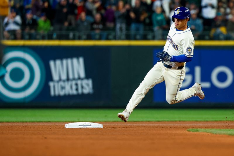 Apr 28, 2024; Seattle, Washington, USA; Seattle Mariners shortstop Leo Rivas (76) advances to third base on a triple against the Arizona Diamondbacks during the third inning at T-Mobile Park. The play was the first major league hit for Rivas. Mandatory Credit: Joe Nicholson-USA TODAY Sports