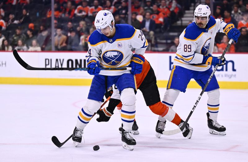 Nov 1, 2023; Philadelphia, Pennsylvania, USA; Buffalo Sabres center Dylan Cozens (24) shields the puck from Philadelphia Flyers defenseman Cam York (8) in the first period at Wells Fargo Center. Mandatory Credit: Kyle Ross-USA TODAY Sports