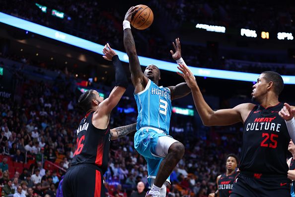 MIAMI, FLORIDA - DECEMBER 13: Terry Rozier #3 of the Charlotte Hornets drives to the basket against Caleb Martin #16 of the Miami Heat during the third quarter of the game at Kaseya Center on December 13, 2023 in Miami, Florida. NOTE TO USER: User expressly acknowledges and agrees that, by downloading and or using this photograph, User is consenting to the terms and conditions of the Getty Images License Agreement. (Photo by Megan Briggs/Getty Images)