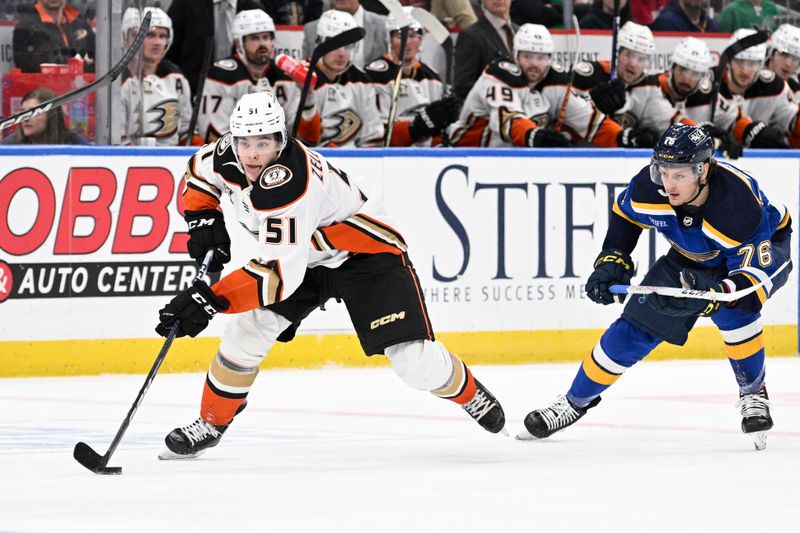 Mar 17, 2024; St. Louis, Missouri, USA; Anaheim Ducks defenseman Olen Zellweger (51) controls the puck from St. Louis Blues center Zack Bolduc (76) during the third period at Enterprise Center. Mandatory Credit: Jeff Le-USA TODAY Sports