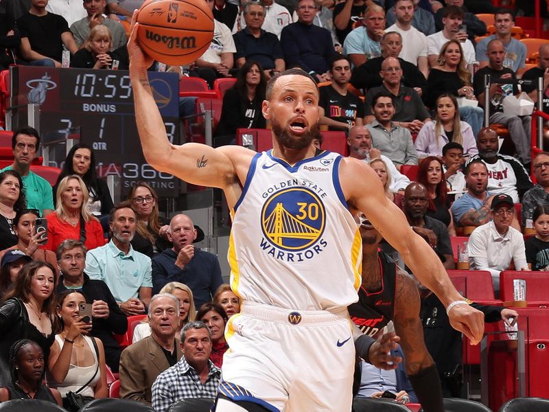MIAMI, FL - MARCH 26:  Stephen Curry #30 of the Golden State Warriors handles the ball during the game against the Miami Heat on March 26, 2024 at Kaseya Center in Miami, Florida. NOTE TO USER: User expressly acknowledges and agrees that, by downloading and or using this Photograph, user is consenting to the terms and conditions of the Getty Images License Agreement. Mandatory Copyright Notice: Copyright 2024 NBAE (Photo by Issac Baldizon/NBAE via Getty Images)