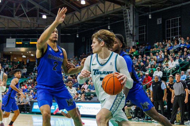 Jan 30, 2025; New Orleans, Louisiana, USA; Tulane Green Wave guard Rowan Brumbaugh (7) dribbles against Memphis Tigers forward Nicholas Jourdain (2) during the second half at Avron B. Fogelman Arena in Devlin Fieldhouse. Mandatory Credit: Stephen Lew-Imagn Images