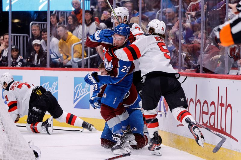 Nov 7, 2023; Denver, Colorado, USA; Colorado Avalanche center Ross Colton (20) gets wrapped up with New Jersey Devils center Dawson Mercer (91) after a play in the second period at Ball Arena. Mandatory Credit: Isaiah J. Downing-USA TODAY Sports