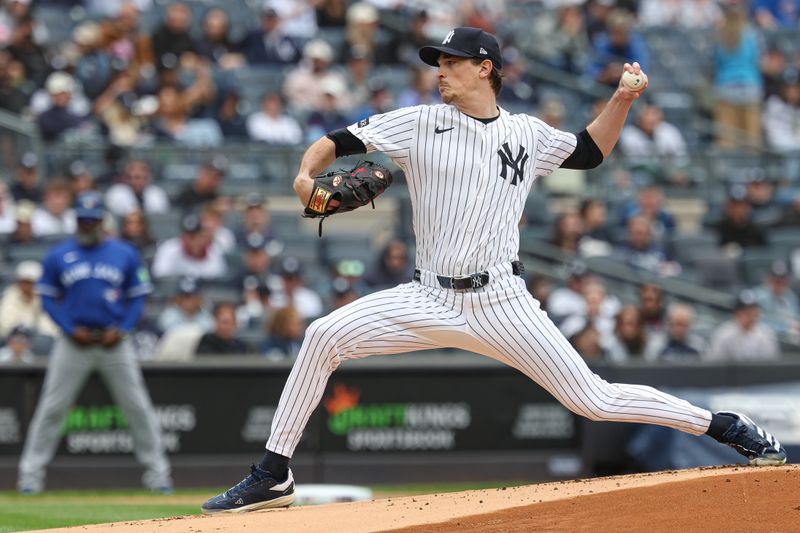 Apr 27, 2025; Bronx, New York, USA;  New York Yankees starting pitcher Max Fried (54) delivers a pitch during the first inning against the Toronto Blue Jays at Yankee Stadium. Mandatory Credit: Vincent Carchietta-Imagn Images