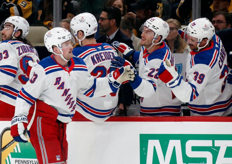 Oct 9, 2024; Pittsburgh, Pennsylvania, USA;  New York Rangers left wing Alexis Lafrenière (13) celebrates with the Rangers bench after scoring a goal against the Pittsburgh Penguins during the first period at PPG Paints Arena. Mandatory Credit: Charles LeClaire-Imagn Images