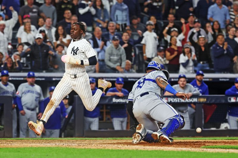 Oct 5, 2024; Bronx, New York, USA; New York Yankees third base Jazz Chisholm Jr. (13) scores a run as Kansas City Royals catcher Salvador Perez (13) was unable to make a save during the seventh inning during game one of the ALDS for the 2024 MLB Playoffs at Yankee Stadium. Mandatory Credit: Vincent Carchietta-Imagn Images