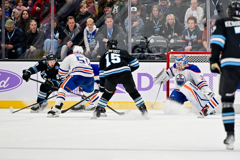 Nov 29, 2024; Salt Lake City, Utah, USA; Edmonton Oilers goaltender Calvin Pickard (30) blocks a shot by Utah Hockey Club left wing Michael Carcone (53) during the third period at the Delta Center. Mandatory Credit: Christopher Creveling-Imagn Images