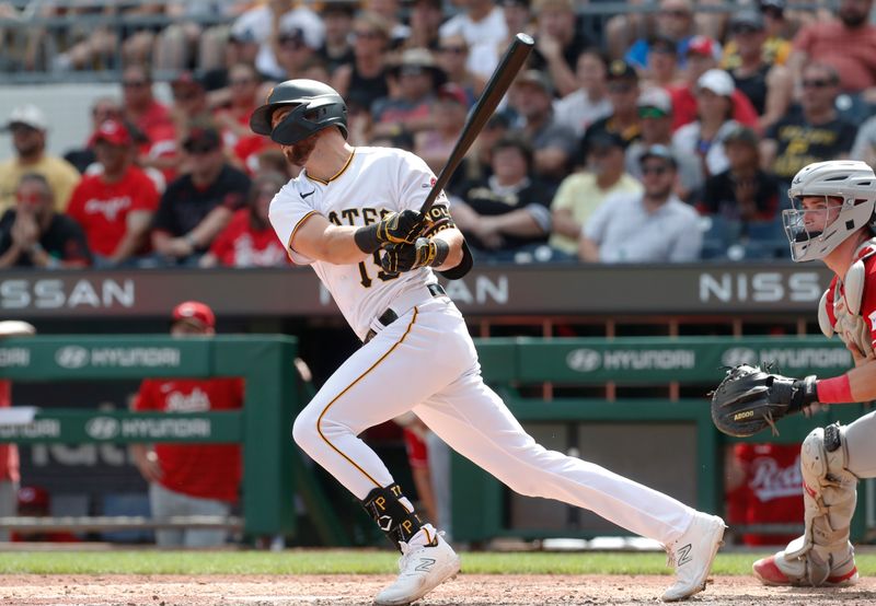 Aug 13, 2023; Pittsburgh, Pennsylvania, USA; Pittsburgh Pirates pinch hitter Jared Triolo (19) hits a three run home run to record his first major league home run against the Cincinnati Reds during the seventh inning at PNC Park. Mandatory Credit: Charles LeClaire-USA TODAY Sports