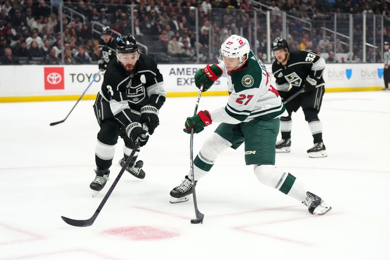 Apr 15, 2024; Los Angeles, California, USA; Minnesota Wild center Jacob Lucchini (27) shoots the puck against LA Kings defenseman Drew Doughty (8) in the first period at Crypto.com Arena. Mandatory Credit: Kirby Lee-USA TODAY Sports