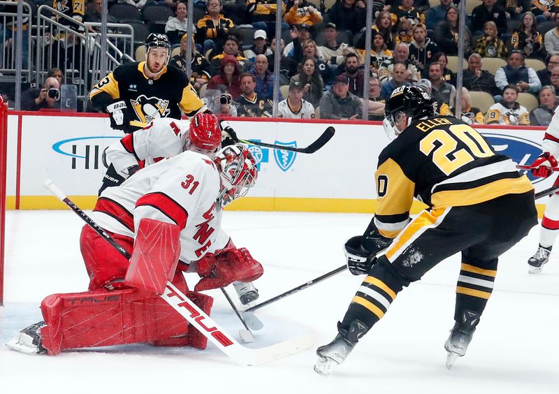 Oct 18, 2024; Pittsburgh, Pennsylvania, USA;  Carolina Hurricanes goaltender Frederik Andersen (31) makes a save against Pittsburgh Penguins center Lars Eller (20) during the third period at PPG Paints Arena. Mandatory Credit: Charles LeClaire-Imagn Images