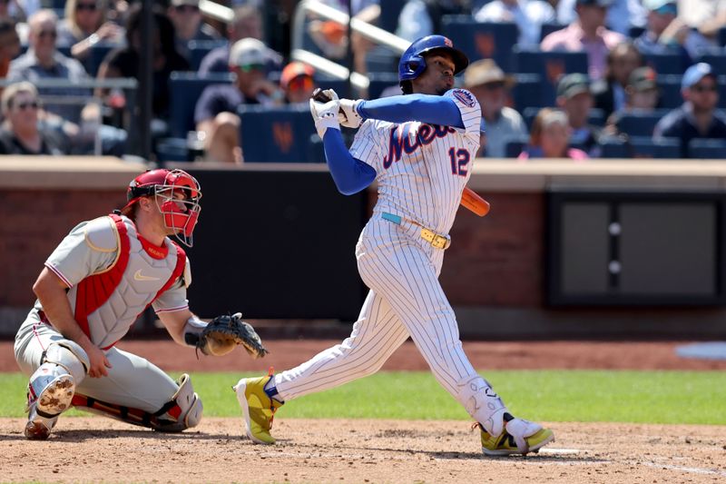 Apr 23, 2025; New York City, New York, USA; New York Mets shortstop Francisco Lindor (12) follows through on a single against the Philadelphia Phillies during the fifth inning at Citi Field. Mandatory Credit: Brad Penner-Imagn Images