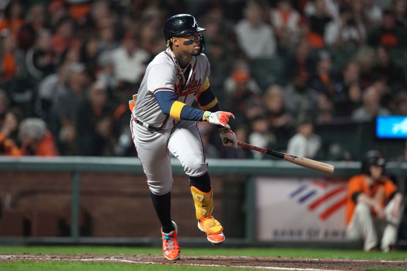 Aug 25, 2023; San Francisco, California, USA; Atlanta Braves right fielder Ronald Acuna Jr. (13) runs to first base after hitting a triple against the San Francisco Giants during the sixth inning at Oracle Park. Mandatory Credit: Darren Yamashita-USA TODAY Sports