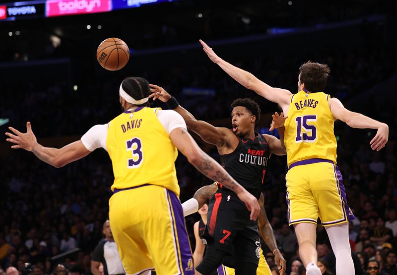 LOS ANGELES, CALIFORNIA - JANUARY 03: Kyle Lowry #7 of the Miami Heat passes out of a double team by Austin Reaves #15 and Anthony Davis #3 of the Los Angeles Lakers during the first half at Crypto.com Arena on January 03, 2024 in Los Angeles, California. (Photo by Harry How/Getty Images)