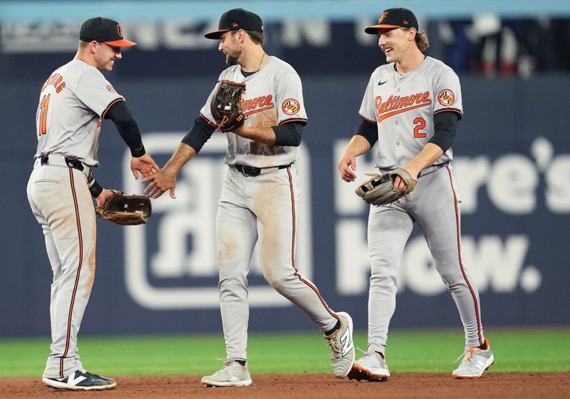 Jun 3, 2024; Toronto, Ontario, CAN; Baltimore Orioles center fielder Colton Cowser (17) celebrates the win with third baseman Jordan Westburg (11) against the Toronto Blue Jays at the end of the ninth inning at Rogers Centre. Mandatory Credit: Nick Turchiaro-USA TODAY Sports