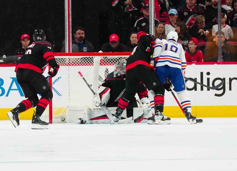 Nov 22, 2023; Raleigh, North Carolina, USA; Edmonton Oilers left wing Zach Hyman (18) scores a goal past Carolina Hurricanes goaltender Pyotr Kochetkov (52) during the third period at PNC Arena. Mandatory Credit: James Guillory-USA TODAY Sports